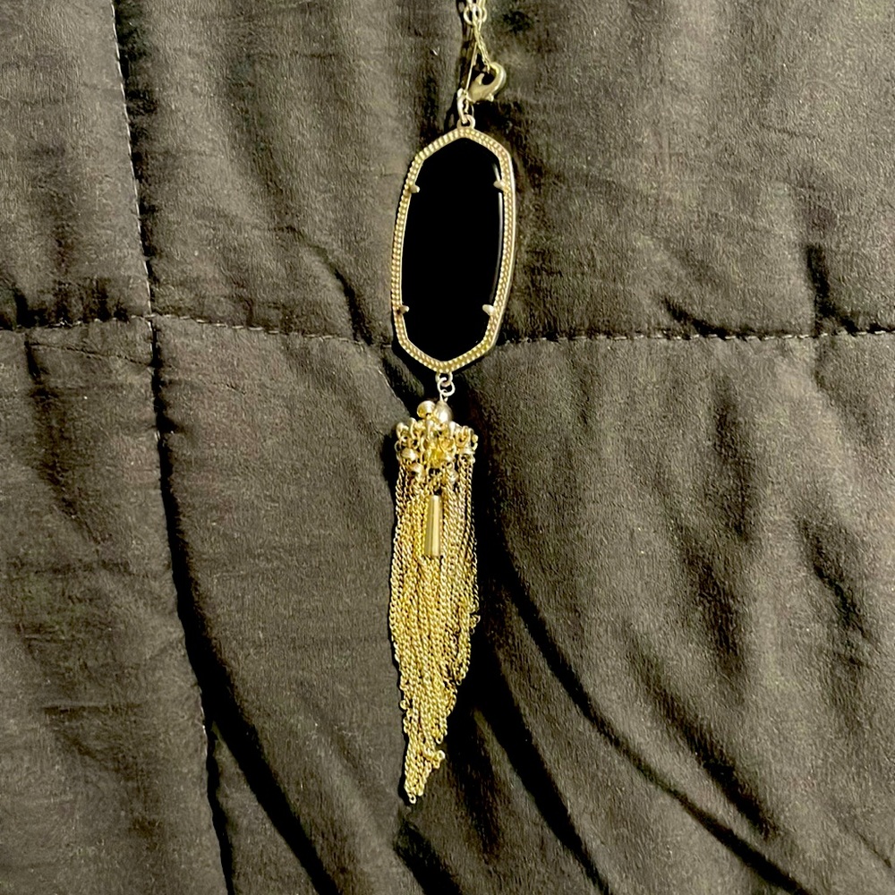 It is is very good condition and is black with a silver chain